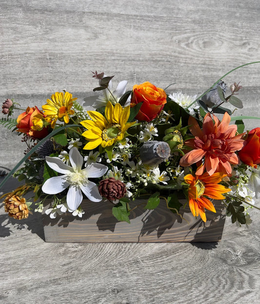 Artificial flowers in a wooden gray rectangular box