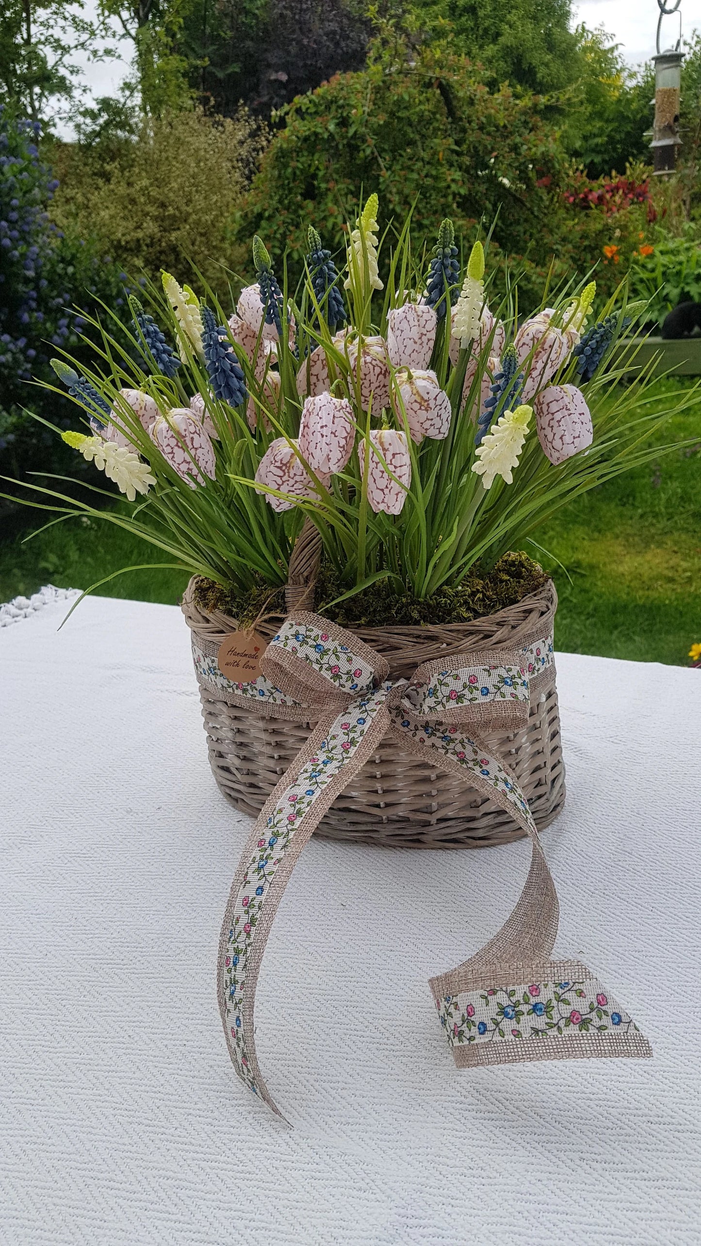 Artificial Flower Arrangement in Wicker/Willow Basket. Snake's Head (Fritillaria meleagris) Grape Hyacinth Grass Natural Moss