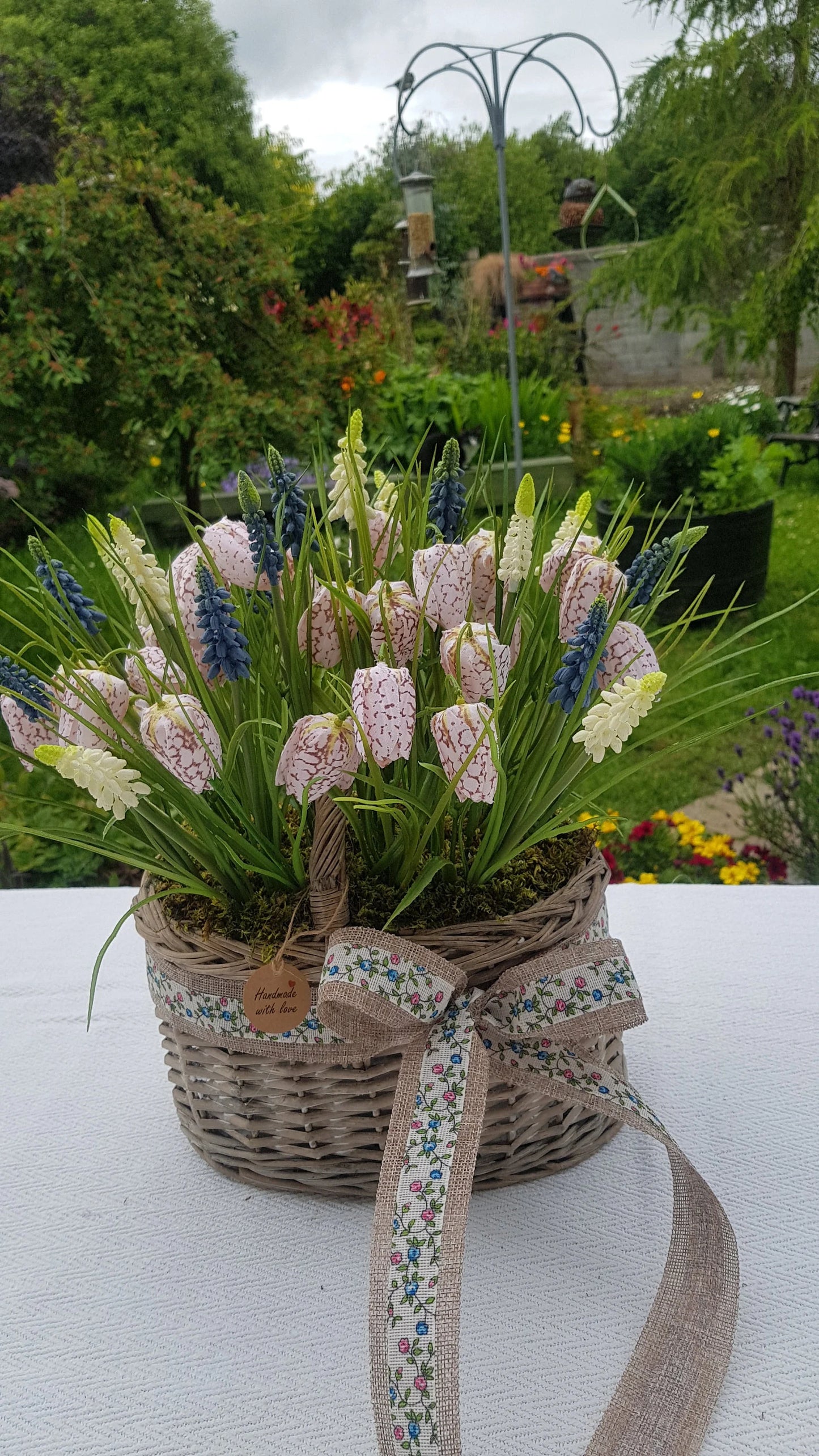 Artificial Flower Arrangement in Wicker/Willow Basket. Snake's Head (Fritillaria meleagris) Grape Hyacinth Grass Natural Moss