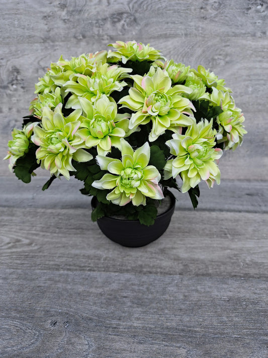 Artificial green chrysanths flower arrangement for grave decoration.